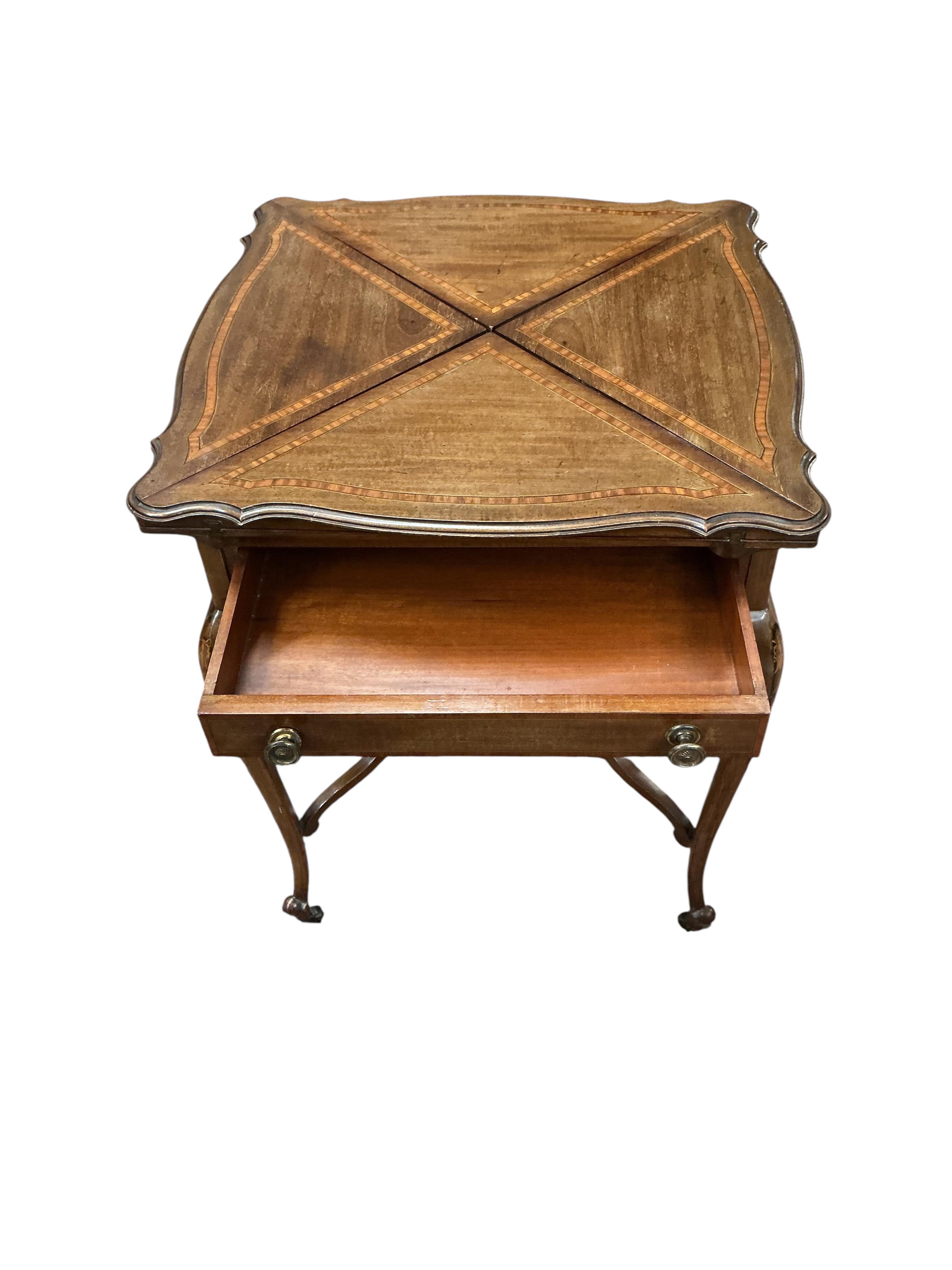 An Edwardian satinwood banded mahogany envelope card table, width 57cm, depth 57cm, height 74cm
